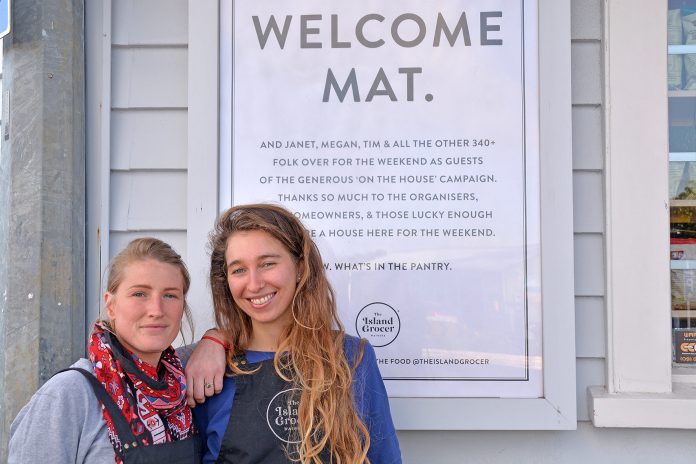 The Island Grocer crew including Manon and Victoria (pictured) came out in support of On The House last weekend putting up this poster welcoming visitors to the island. Owners Nicky and Simon Cairns say they noticed a lot of positivity from curious visitors and they felt a slightly festive atmosphere in Oneroa village. Photo Sophie Boladeras